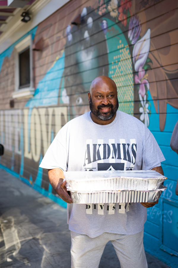 Food Rescuer carrying trays of food